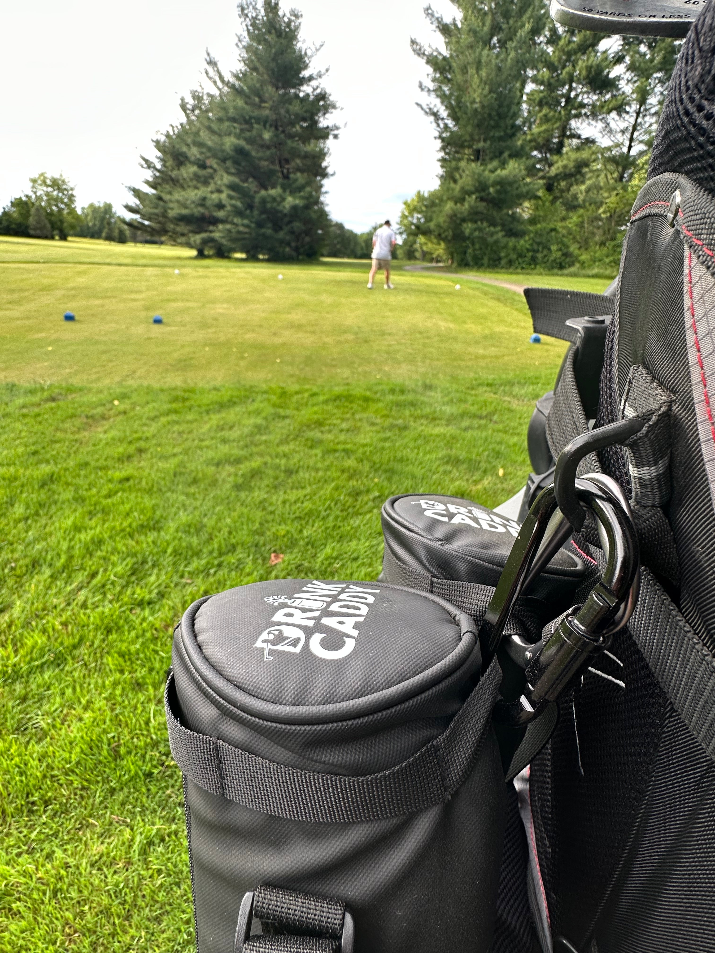 golfer in a golf field using Drink Caddy