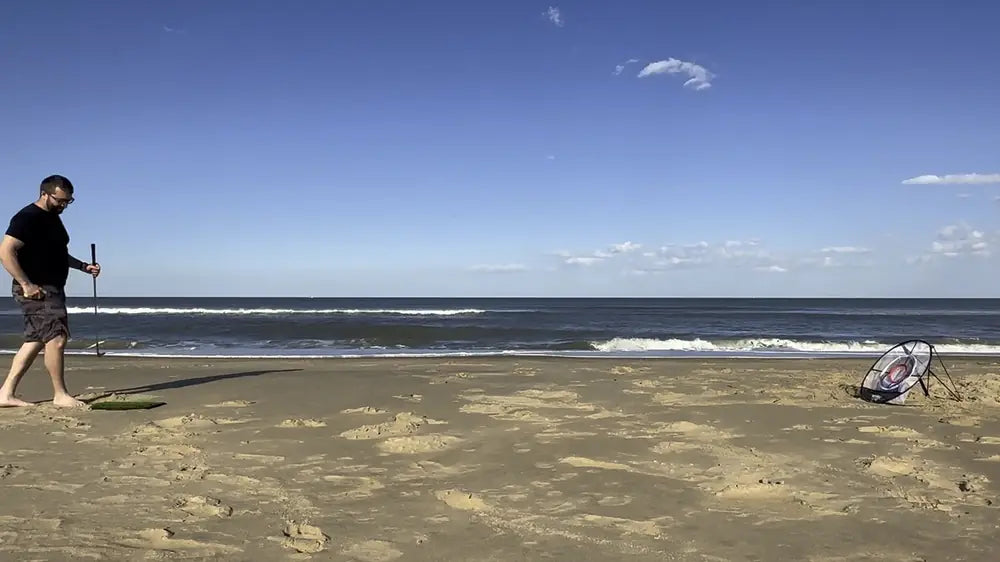 Frank DeLuca chipping on a beach toward a Wedge Master net