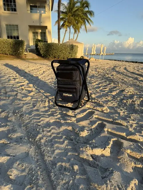 Navy StoolPak on sand in front of a beach house