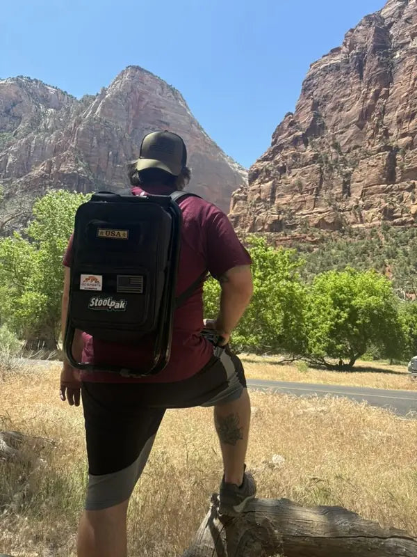 Adult wearing a black StoolPak on a canyon trail